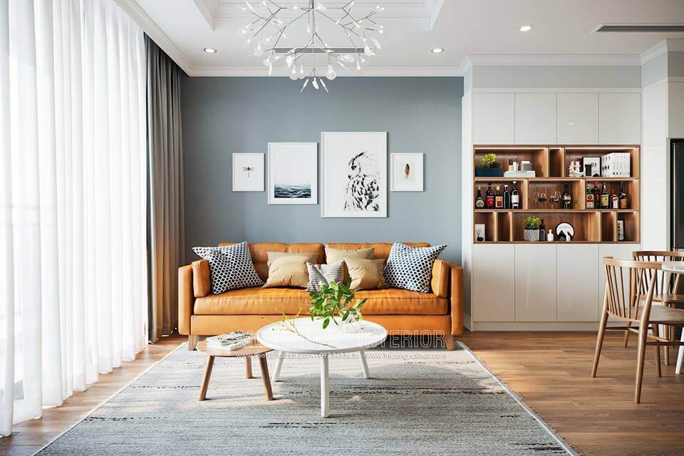 Mảng tường đối diện được đặt 1 chiếc kệ tivi bằng gỗ kiểu cách hiện đại chi tiết đơn giản nhưng tiện nghi nhất định. Chiếc kệ trang trí ngang được đặt trên cao giúp cho mảng tường không còn trống trải. Mẫu nội thất chung cư hiện đại